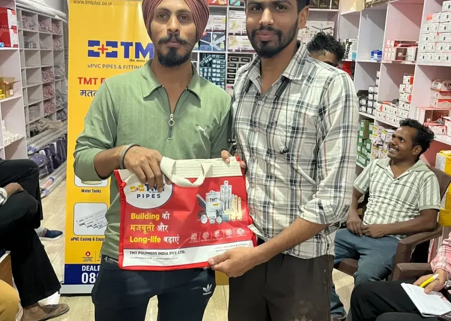A PVC pipe dealer receiving a Saathi Samreedhi reward at the counter